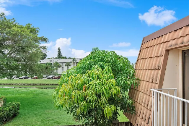 a view of a garden with a house in the background