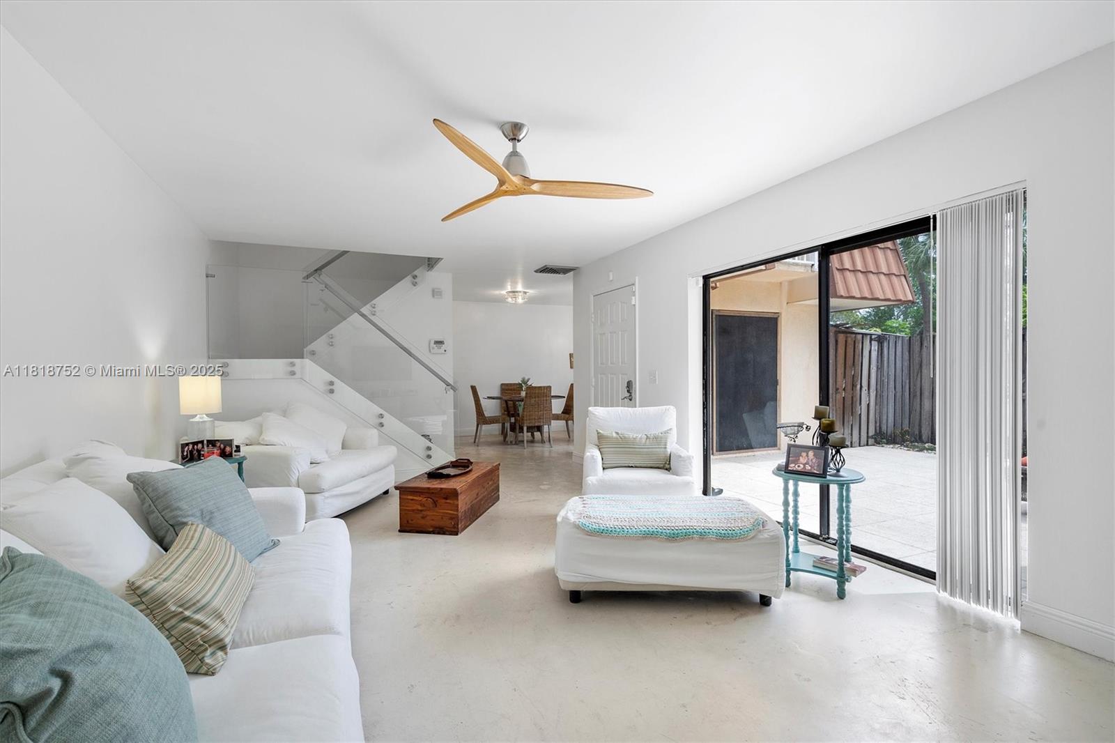 839 Blue Ridge Circle, Unit 839 West Palm Beach, FL 33409 - Photo 2 of 34 a living room with furniture and a chandelier