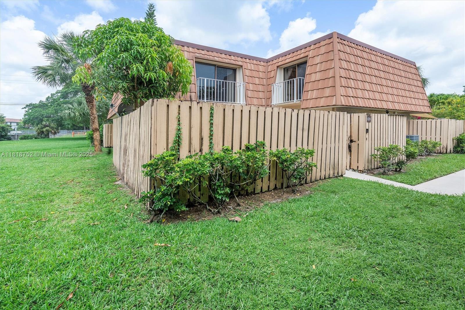 839 Blue Ridge Circle, Unit 839 West Palm Beach, FL 33409 - Photo 22 of 34 a front view of a house with garden