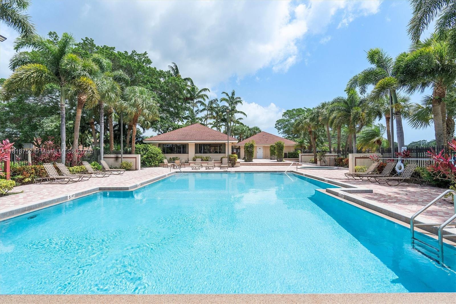 839 Blue Ridge Circle, Unit 839 West Palm Beach, FL 33409 - Photo 23 of 34 a view of a house with swimming pool and sitting area