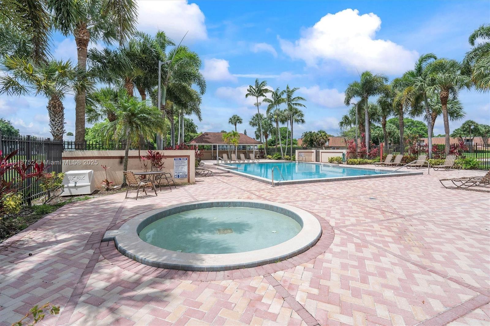 839 Blue Ridge Circle, Unit 839 West Palm Beach, FL 33409 - Photo 25 of 34 a view of a swimming pool with a yard