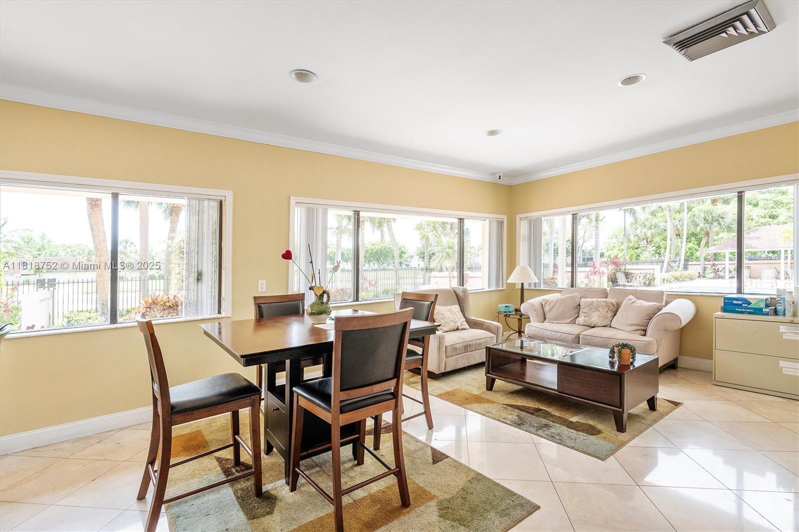 839 Blue Ridge Circle, Unit 839 West Palm Beach, FL 33409 - Photo 27 of 34 a living room with furniture and a large window