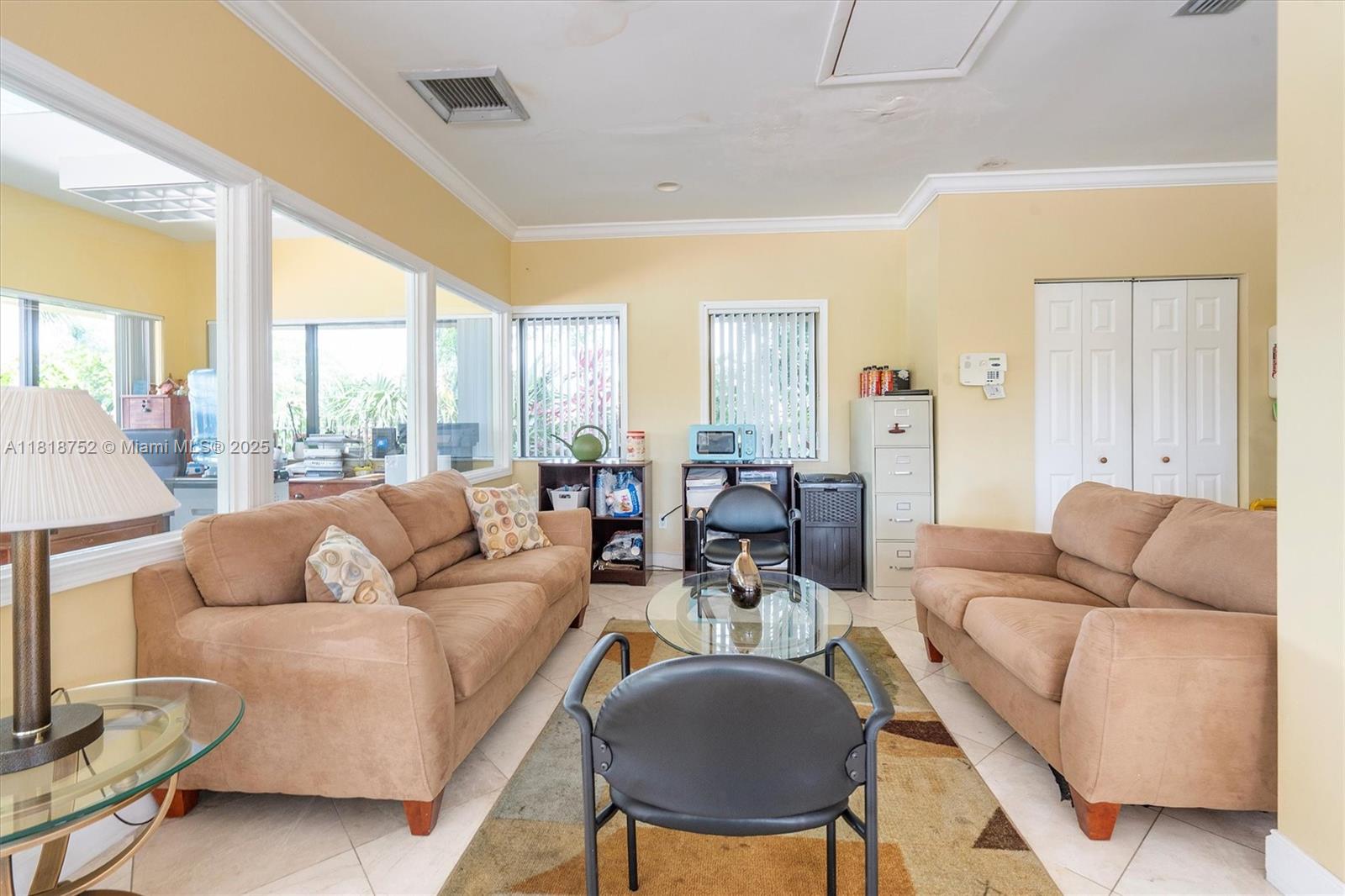 839 Blue Ridge Circle, Unit 839 West Palm Beach, FL 33409 - Photo 28 of 34 a living room with furniture and a large window