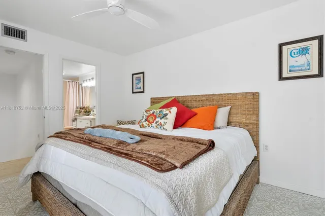 a bedroom with a bed and a painting on the wall