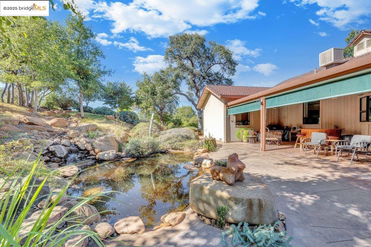 13700 Clements Road Groveland, CA 95321 - Photo 54 of 93 View of yard with a garden pond and a patio area