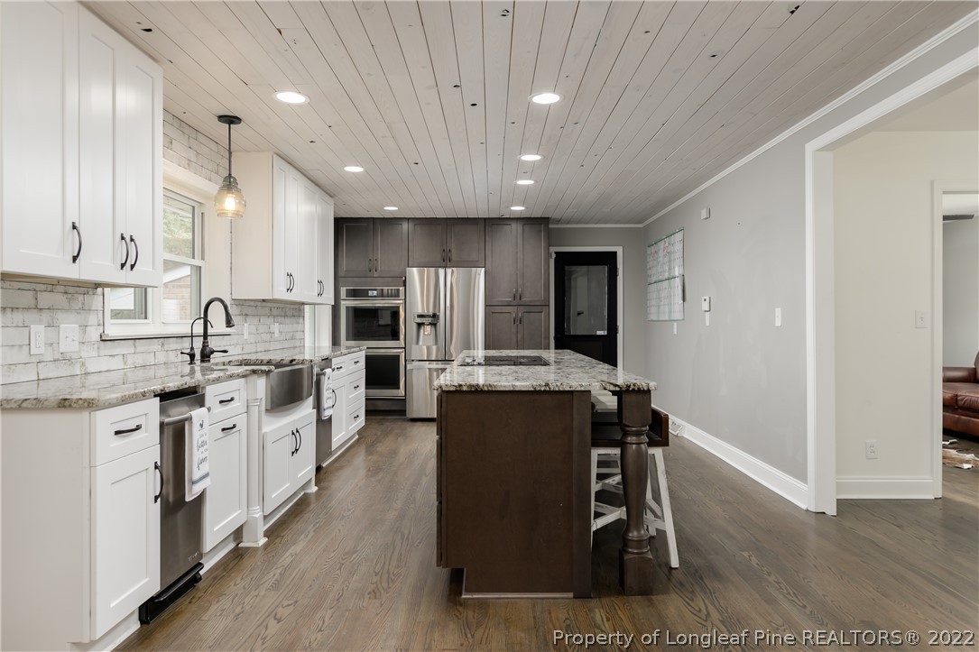 190 Valhalla Road Southern Pines, NC 28387 - Photo 11 of 39 a kitchen with counter top space cabinets and stainless steel appliances