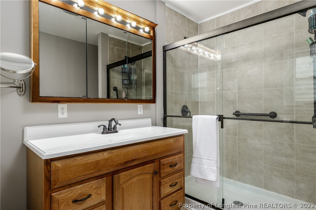 190 Valhalla Road Southern Pines, NC 28387 - Photo 18 of 39 a bathroom with a sink and a mirror