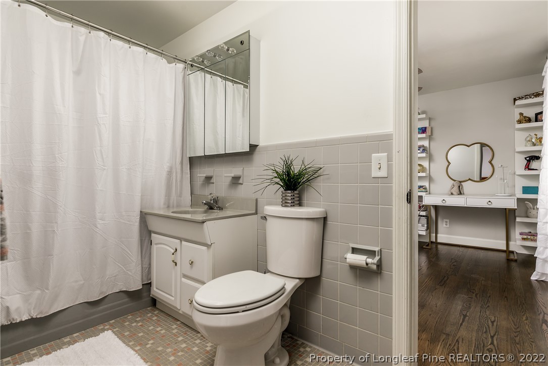 190 Valhalla Road Southern Pines, NC 28387 - Photo 21 of 39 a bathroom with a toilet a sink and a mirror
