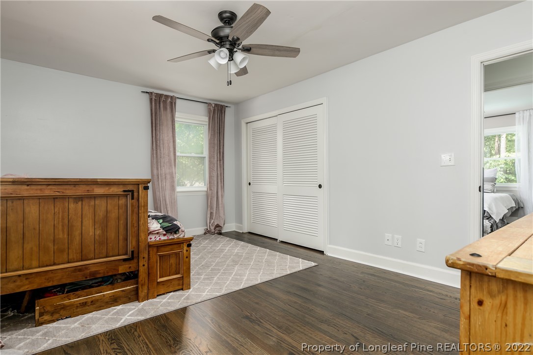 190 Valhalla Road Southern Pines, NC 28387 - Photo 23 of 39 an empty room with wooden floor cabinet and windows
