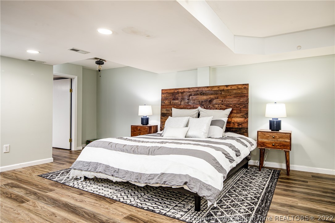 190 Valhalla Road Southern Pines, NC 28387 - Photo 29 of 39 a bedroom with a bed and a night stand