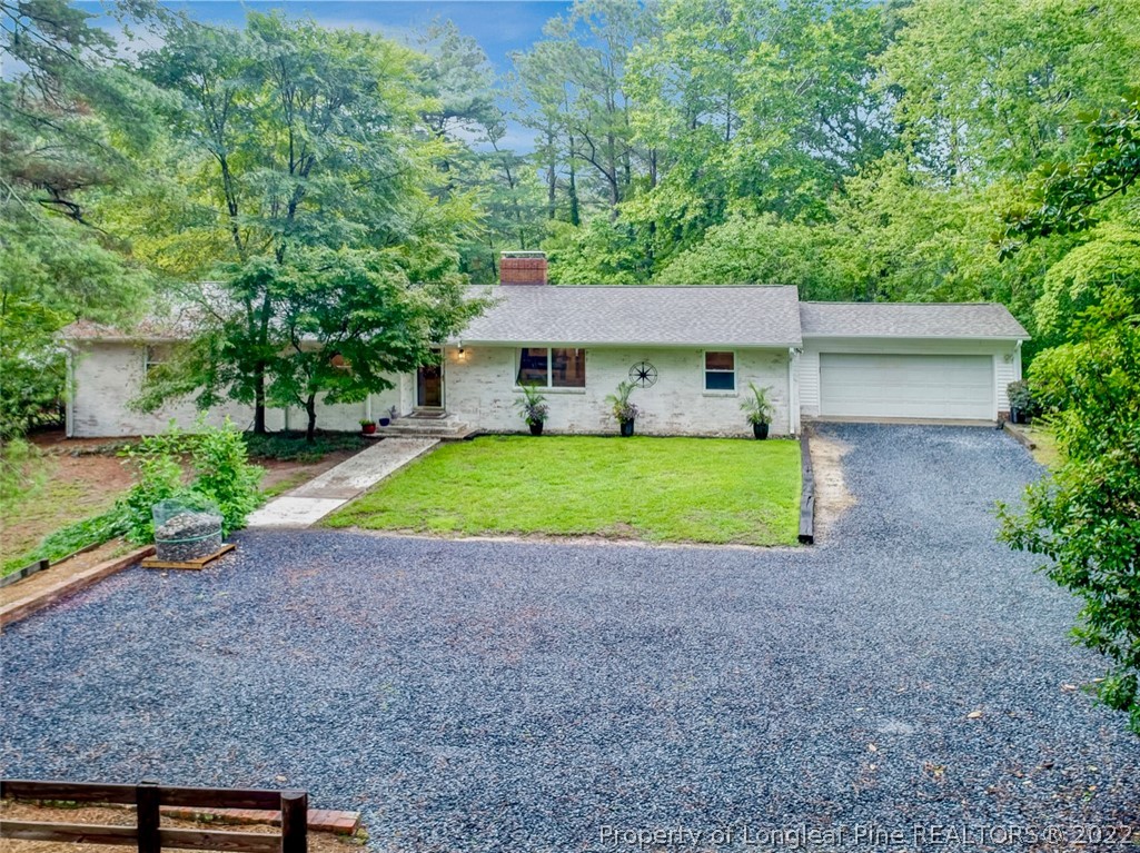 190 Valhalla Road Southern Pines, NC 28387 - Photo 36 of 39 a view of a house with a backyard and garden