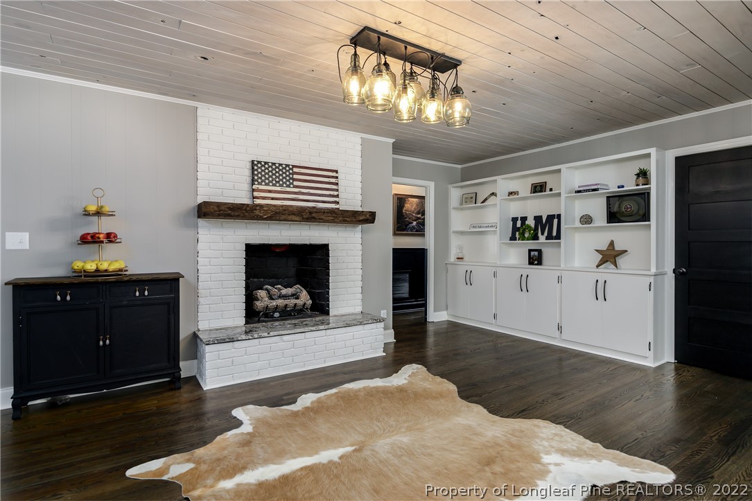 190 Valhalla Road Southern Pines, NC 28387 - Photo 9 of 39 a living room with furniture and a fireplace