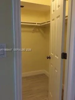 a view of room with window and wooden floor