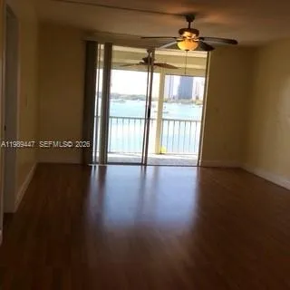 a view of a livingroom with a furniture wooden floor and chandelier