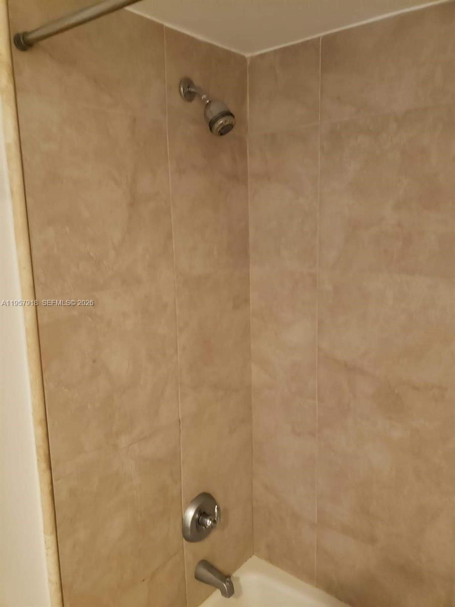 401 69th Street, Unit 906 Miami Beach, FL 33141 - Photo 19 of 24 a bathroom with a shower and a toilet