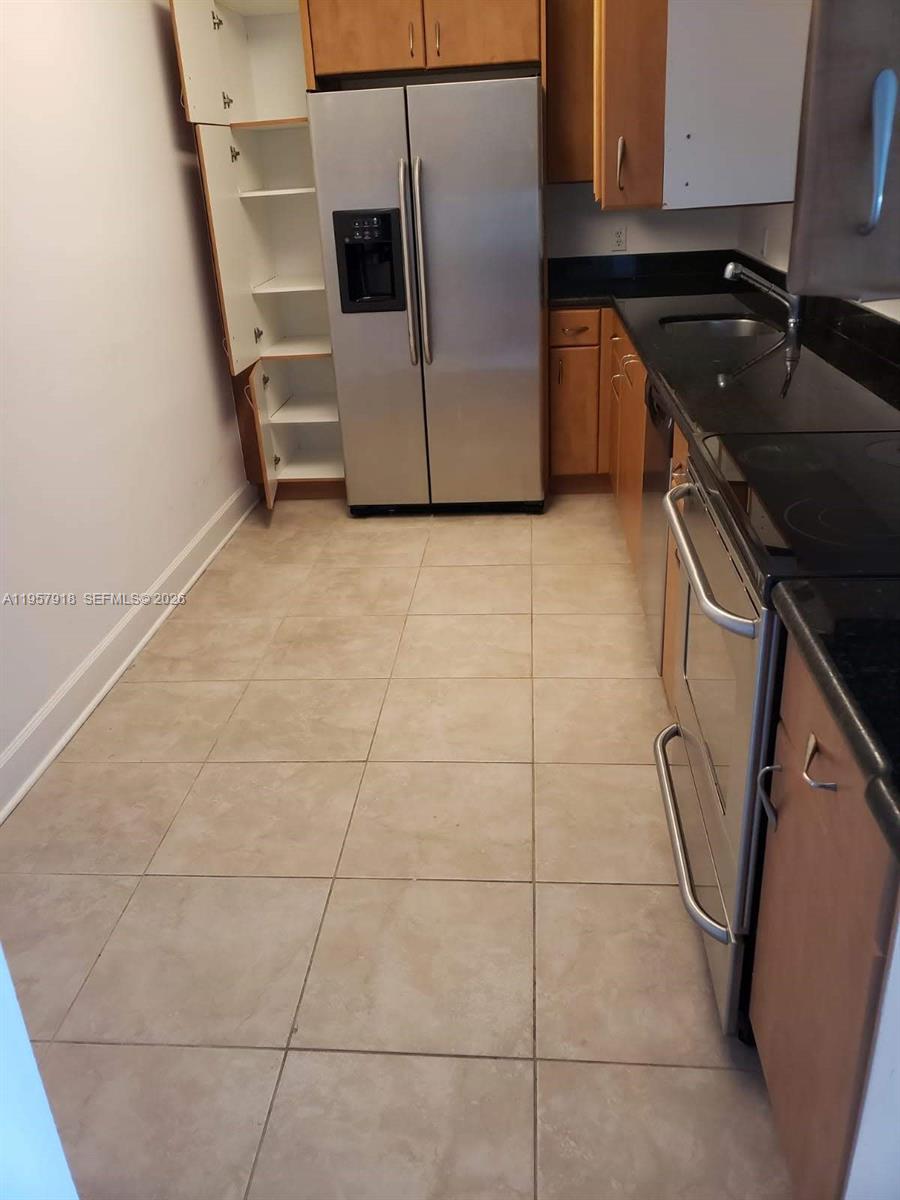 401 69th Street, Unit 906 Miami Beach, FL 33141 - Photo 24 of 24 a kitchen with a sink a stove and cabinets