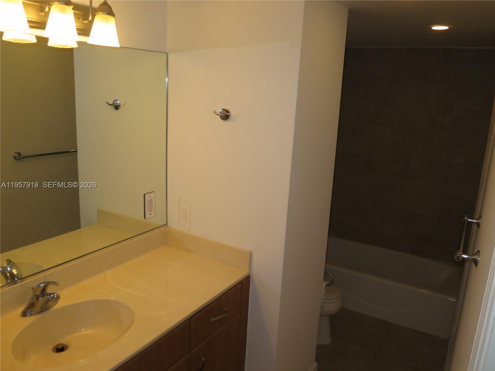 401 69th Street, Unit 906 Miami Beach, FL 33141 - Photo 5 of 24 a bathroom with a tub and sink