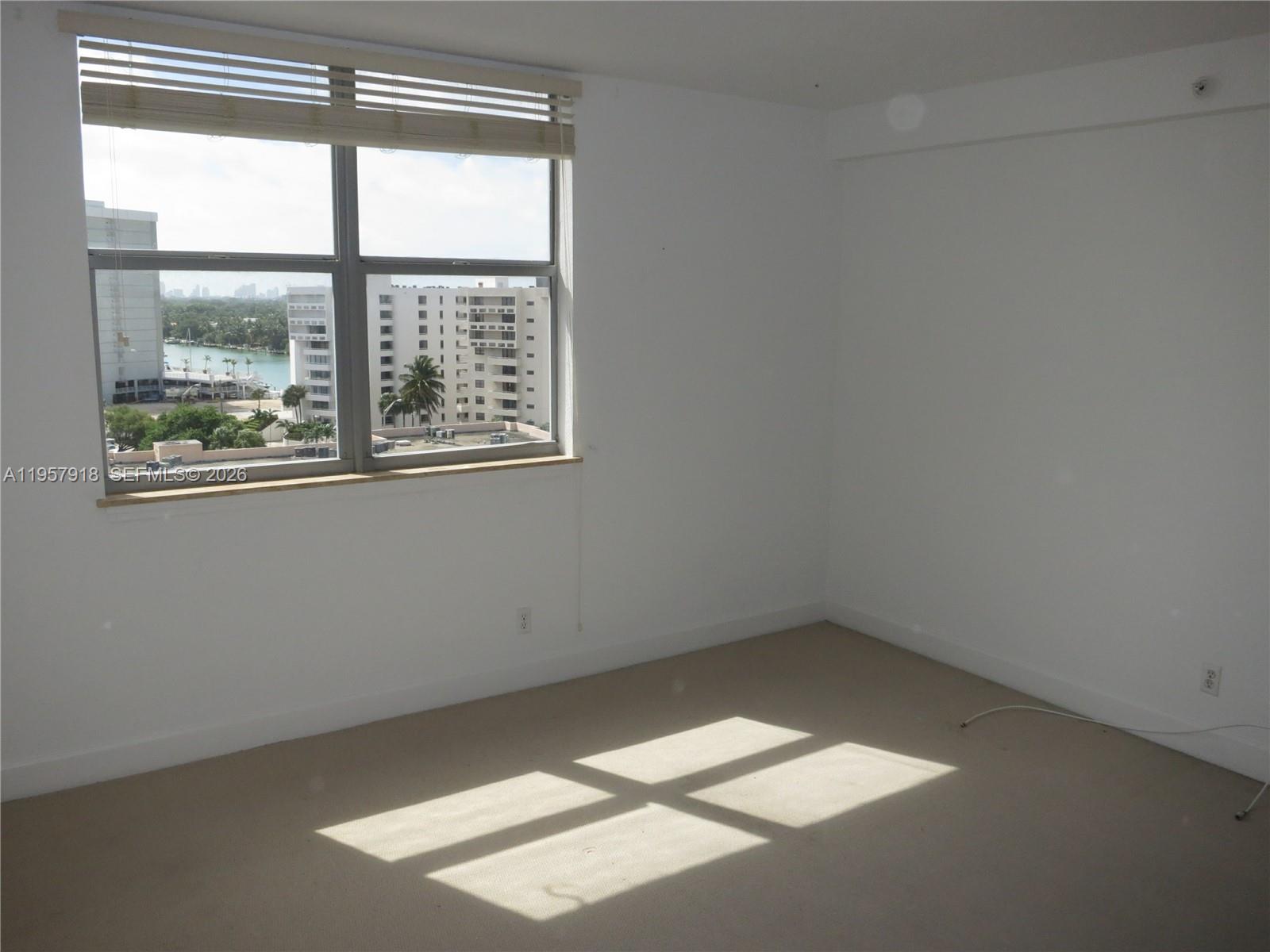 401 69th Street, Unit 906 Miami Beach, FL 33141 - Photo 8 of 24 an empty room with a window