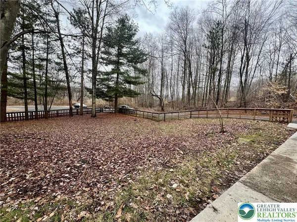 a view of a backyard with wooden fence