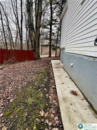 a pathway of a house with a yard