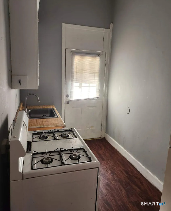 76 Lincoln Street, Unit 1N Meriden, CT 06451 - Photo 3 of 4 a kitchen with a stove and wooden floor
