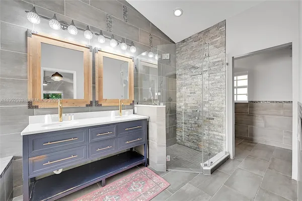a bathroom with a double vanity sink and a mirror