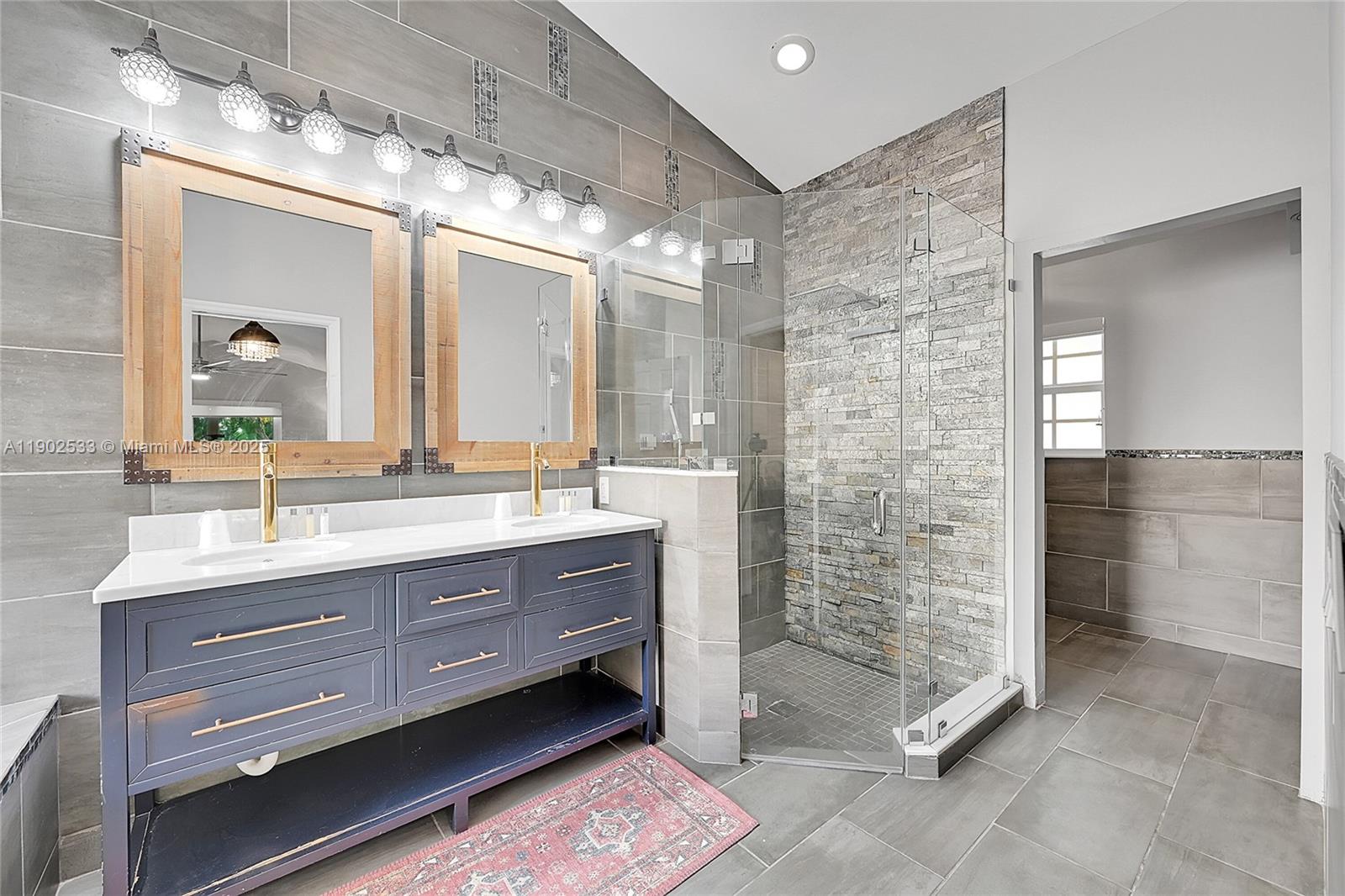 9841 Southwest 1st Street, Unit 9841 Plantation, FL 33324 - Photo 14 of 37 a bathroom with a double vanity sink and a mirror