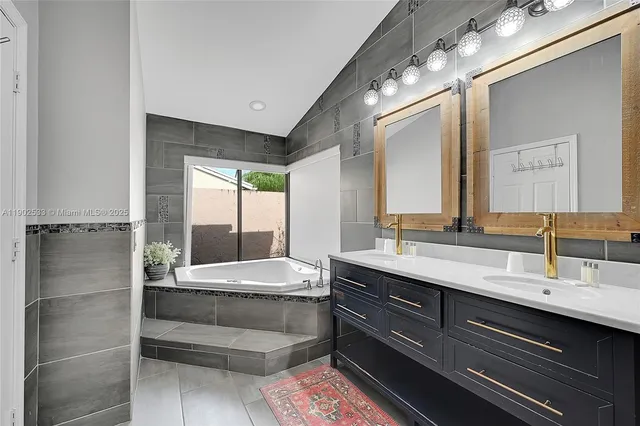 a bathroom with a double vanity sink and a mirror