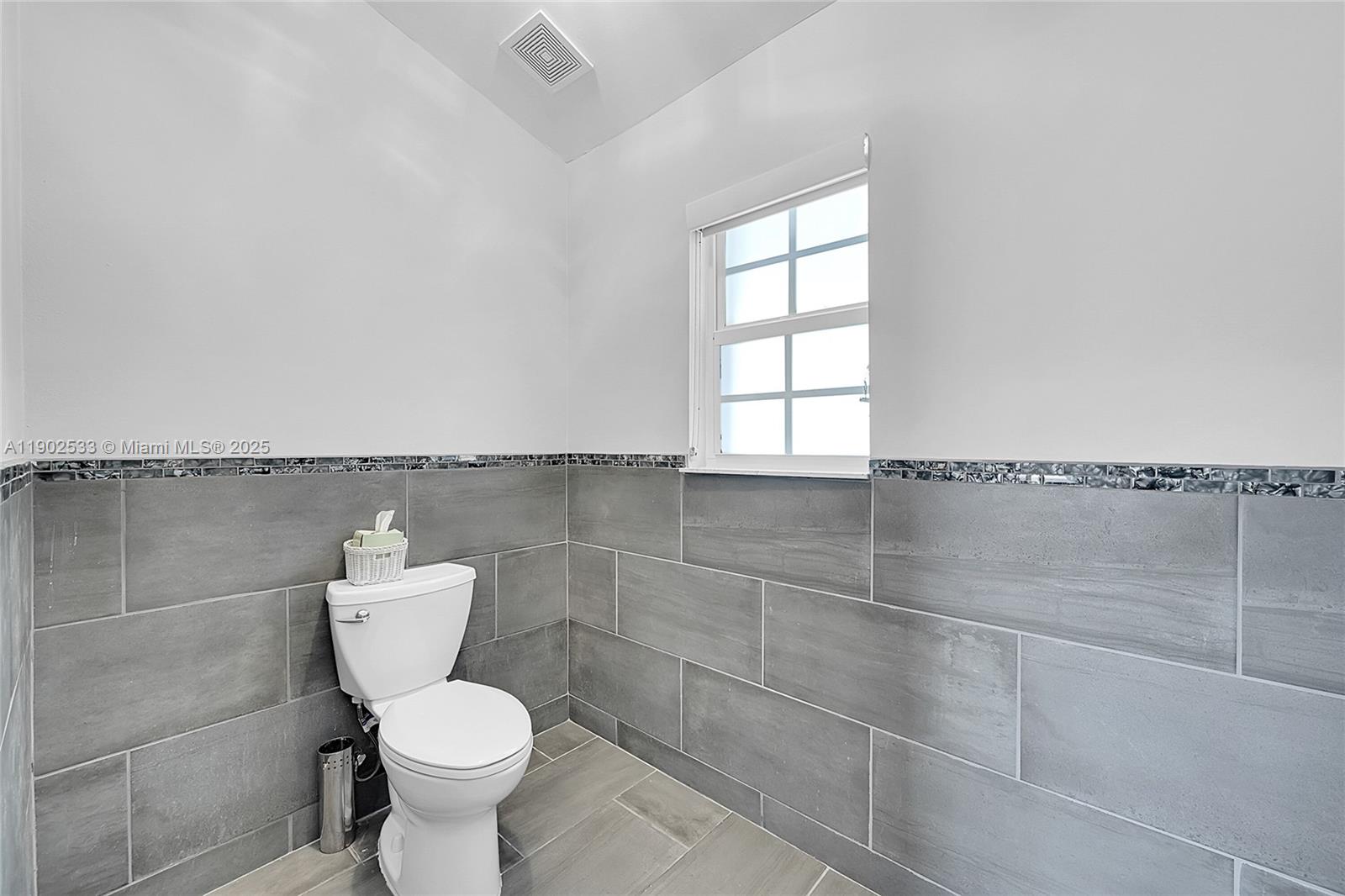 9841 Southwest 1st Street, Unit 9841 Plantation, FL 33324 - Photo 16 of 37 a bathroom with a toilet and a window