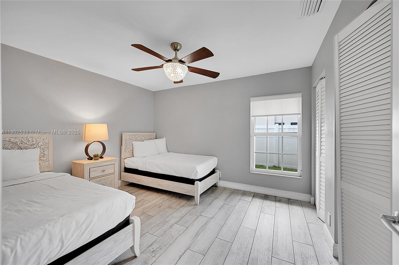 9841 Southwest 1st Street, Unit 9841 Plantation, FL 33324 - Photo 17 of 37 a bedroom with a bed and window