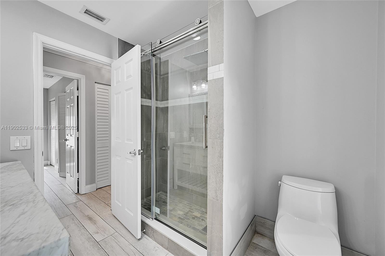 9841 Southwest 1st Street, Unit 9841 Plantation, FL 33324 - Photo 23 of 37 a bathroom with a shower a toilet and a sink