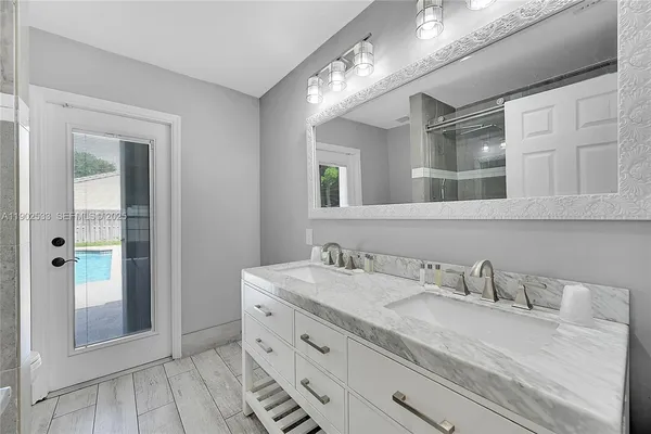 a bathroom with a granite countertop sink mirror and vanity