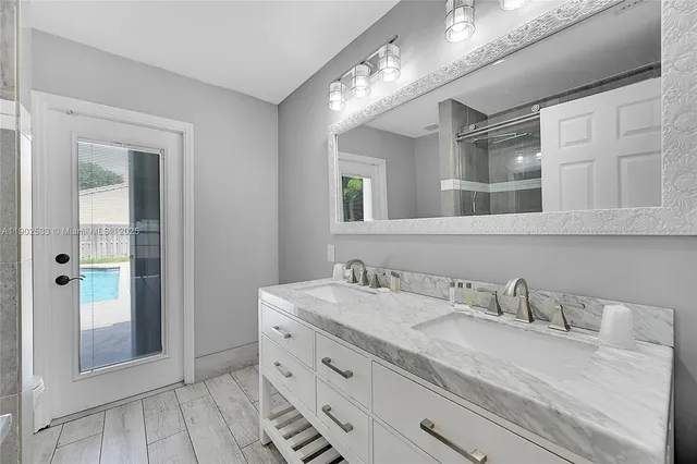 a bathroom with a granite countertop sink mirror and vanity