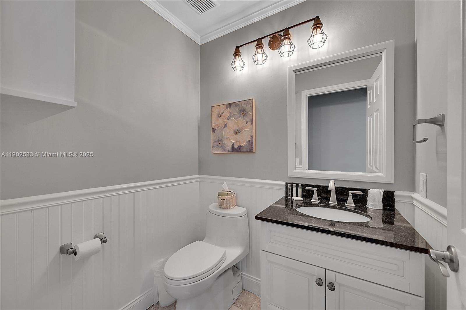 9841 Southwest 1st Street, Unit 9841 Plantation, FL 33324 - Photo 26 of 37 a bathroom with a toilet a sink and mirror