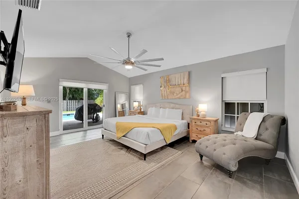 a spacious bedroom with a bed couch and window