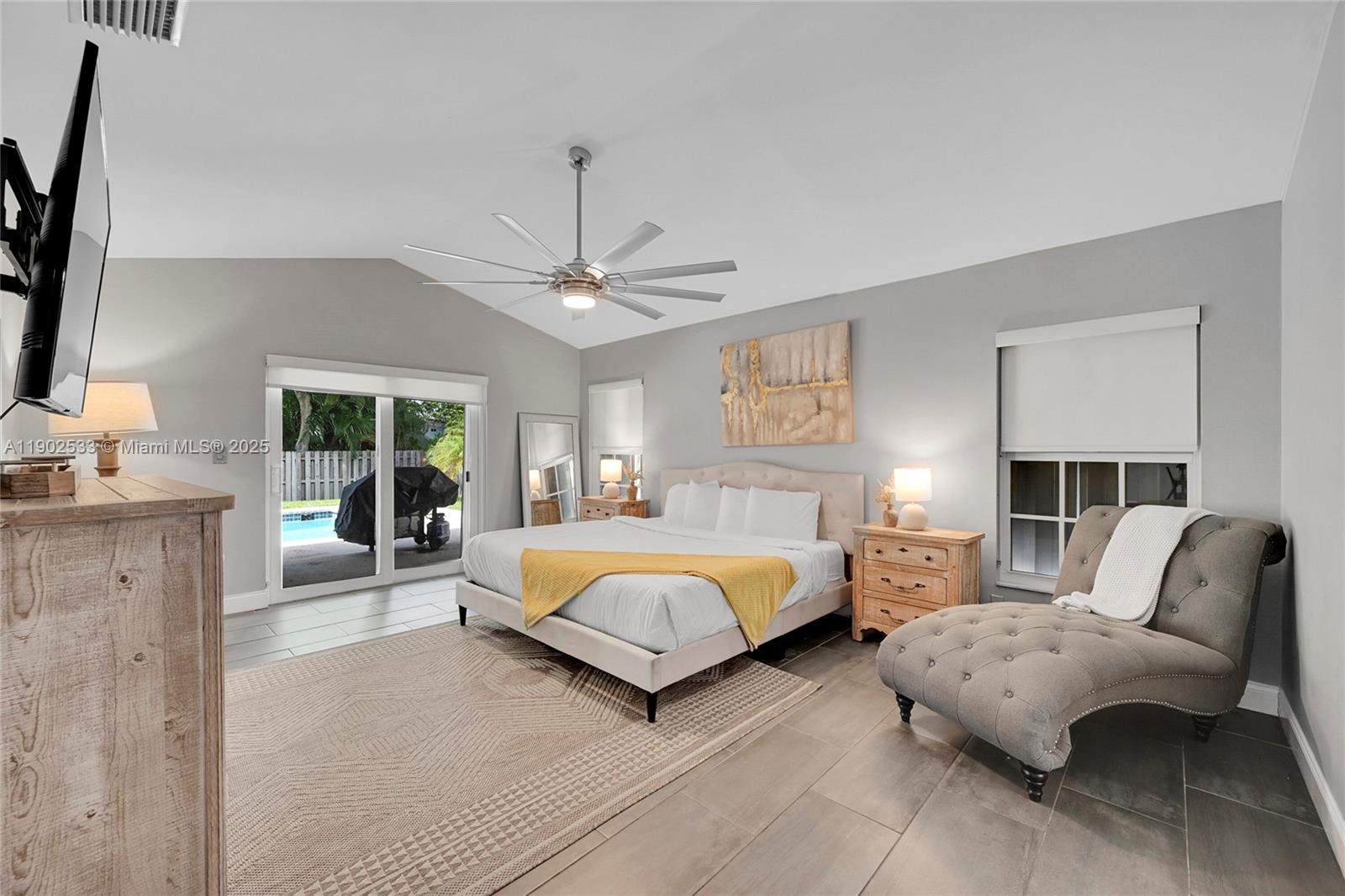 9841 Southwest 1st Street, Unit 9841 Plantation, FL 33324 - Photo 27 of 37 a spacious bedroom with a bed and a couch