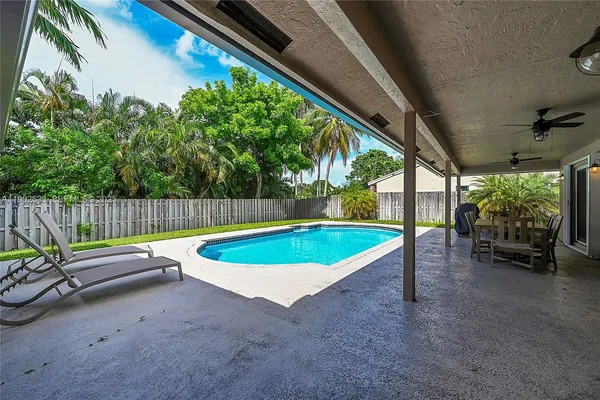 a view of a backyard with swimming pool