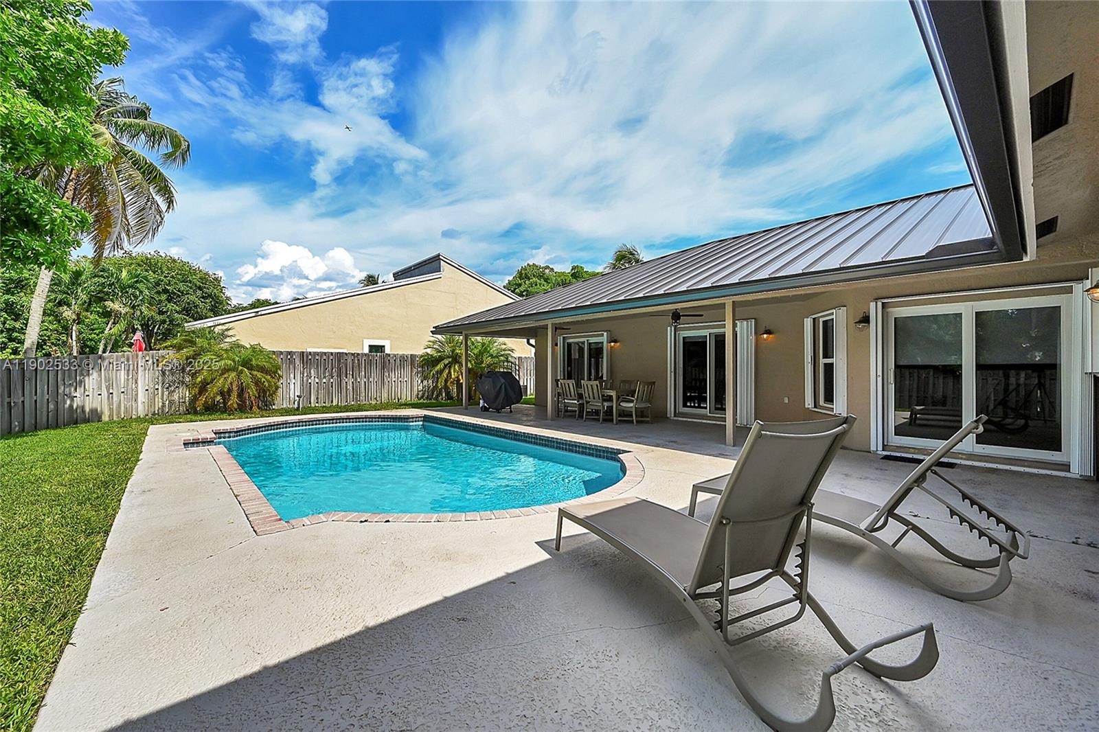 9841 Southwest 1st Street, Unit 9841 Plantation, FL 33324 - Photo 36 of 37 a view of a house with backyard sitting area and garden