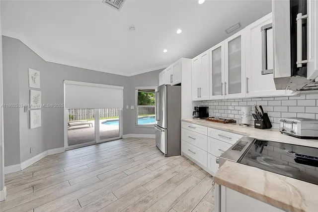 a kitchen with stainless steel appliances cabinets a sink and a stove