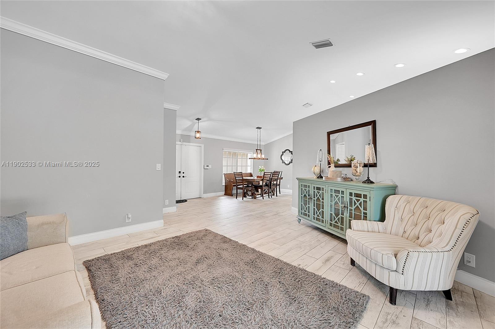 9841 Southwest 1st Street, Unit 9841 Plantation, FL 33324 - Photo 9 of 37 a living room with furniture and a table