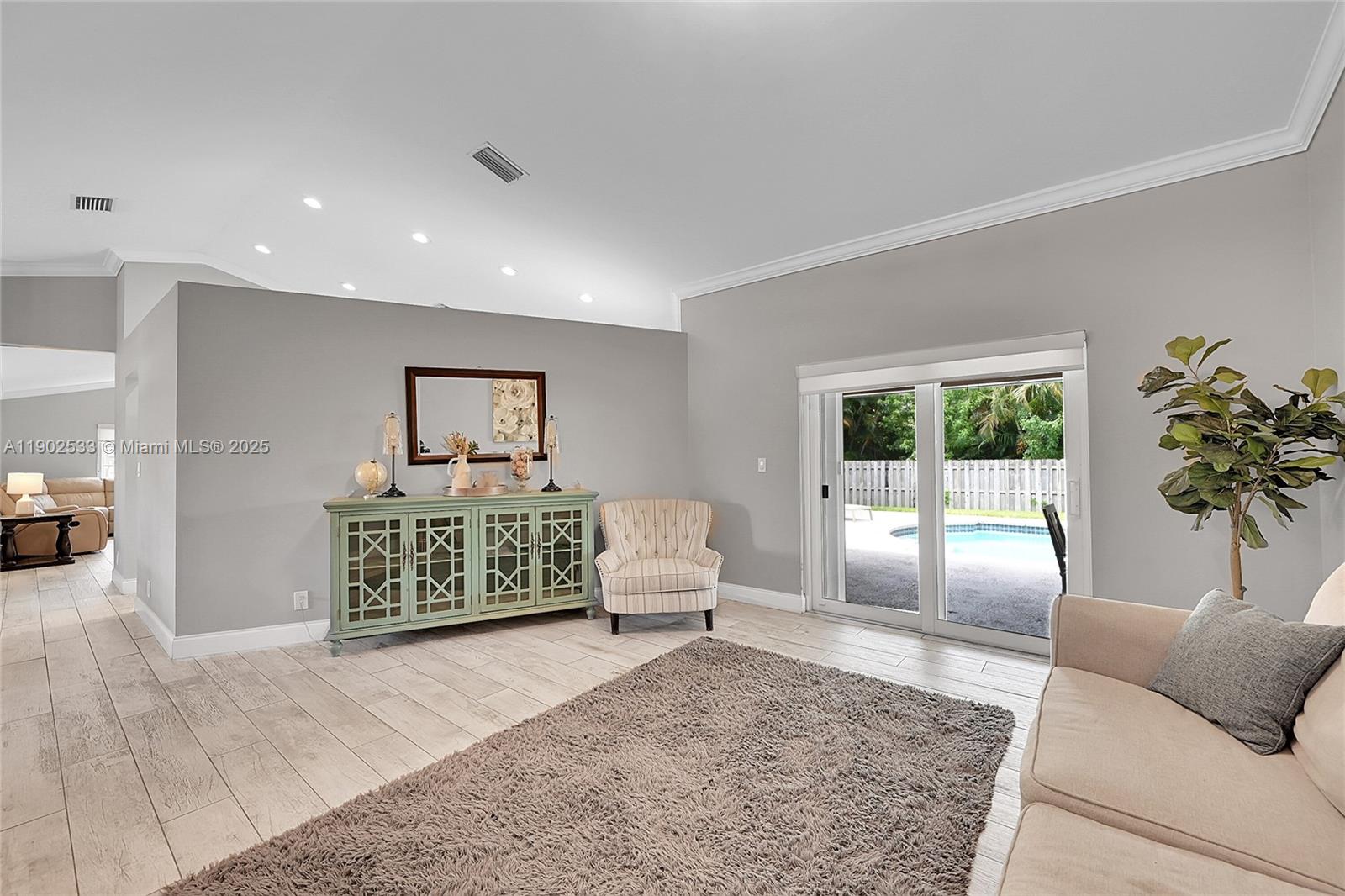 9841 Southwest 1st Street, Unit 9841 Plantation, FL 33324 - Photo 10 of 37 a living room with furniture and a large window