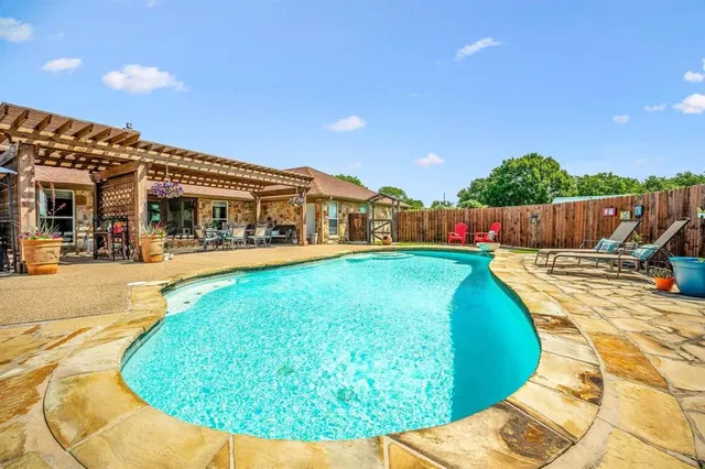 a view of a swimming pool with a lounge chairs