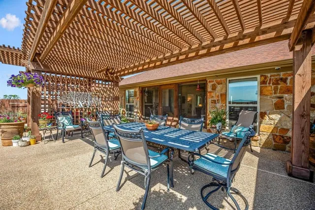 a view of a patio with table and chairs and potted plants