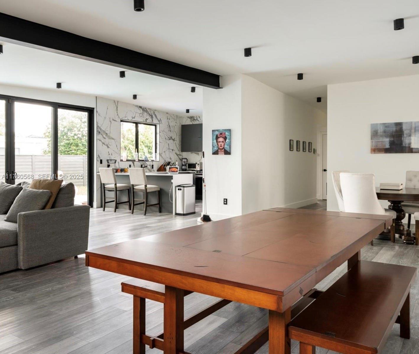 19600 Northeast 19th Avenue Miami, FL 33179 - Photo 12 of 33 a living room with furniture wooden floor and a large window