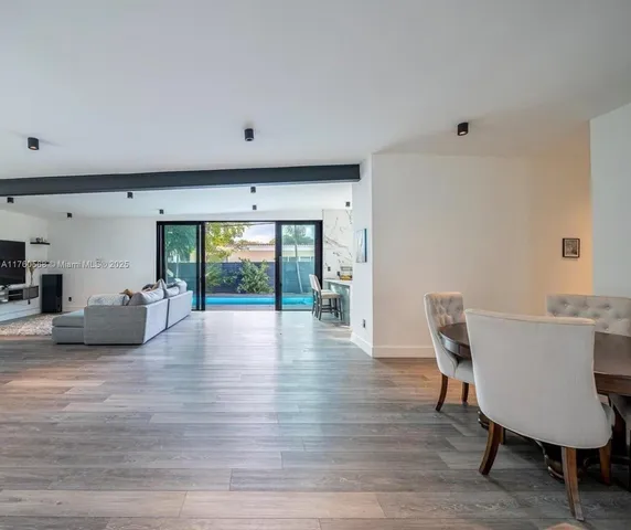 a view of a livingroom with furniture window and wooden floor