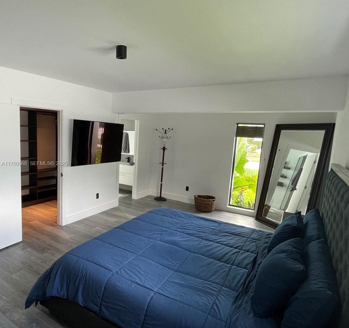 19600 Northeast 19th Avenue Miami, FL 33179 - Photo 16 of 33 a bedroom with a bed and a large window