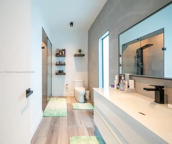 a spacious bedroom with a bed and a large mirror