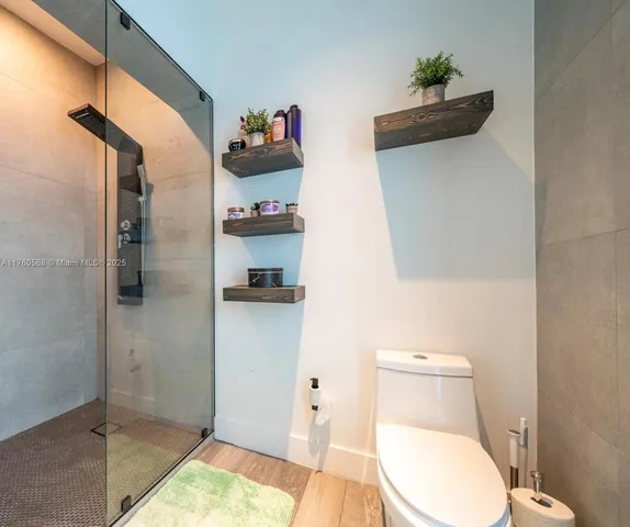 a bathroom with a toilet and a shower