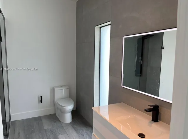 a bathroom with a sink and toilet