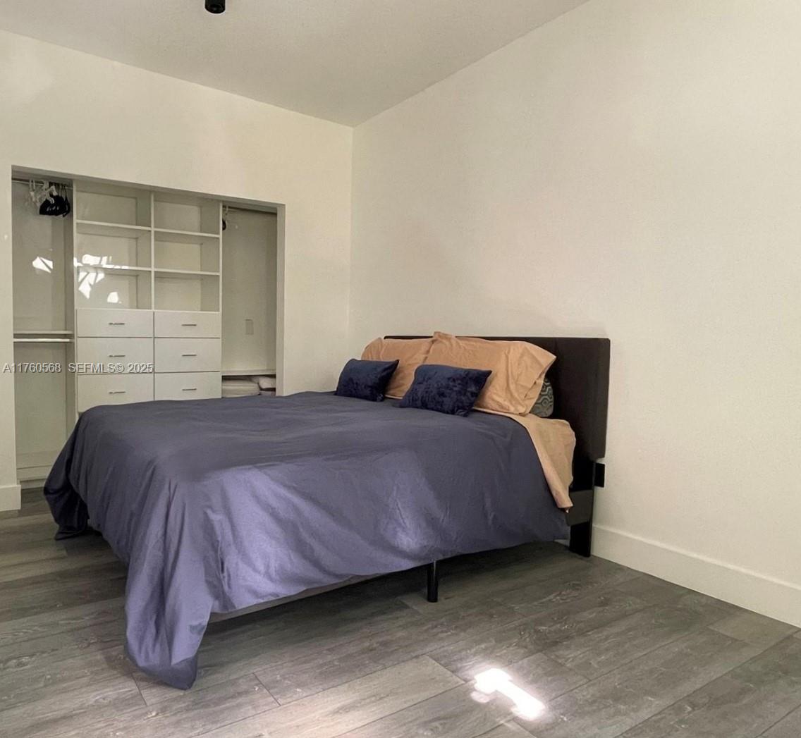 19600 Northeast 19th Avenue Miami, FL 33179 - Photo 21 of 33 a bedroom with a bed and window